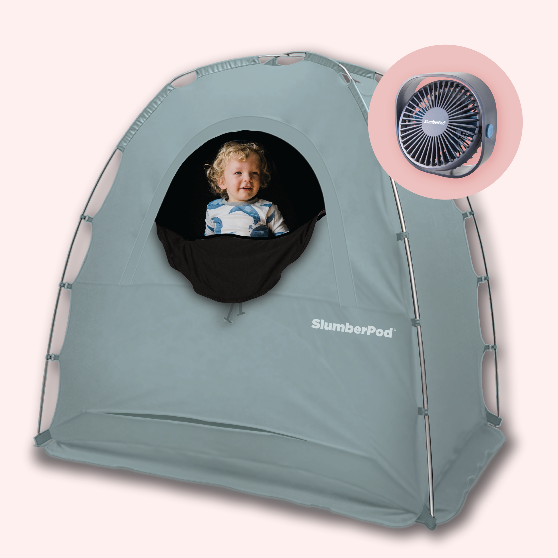 A light blue SlumberPod portable sleep tent for toddlers, featuring a black mesh window where a smiling young boy is visible. The tent has a sturdy, arched frame and the 'SlumberPod' logo printed in white near the bottom. In the upper right corner, a circular inset shows a dark gray portable fan designed to fit the tent's integrated fan pocket.