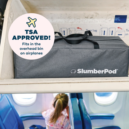 Gray SlumberPod bag with TSA Approved label in an airplane overhead bin.