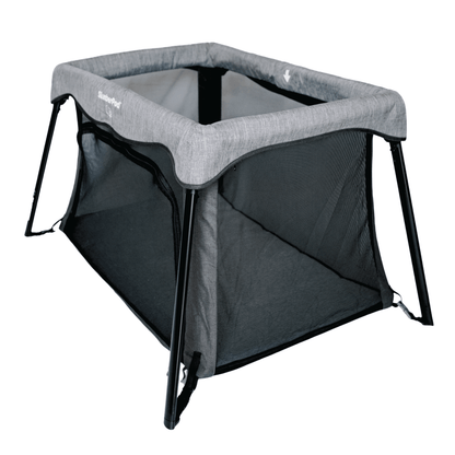 Portable baby crib with gray top and black bottom on a white background
