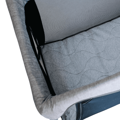 Gray crib mattress with wavy pattern on a white background