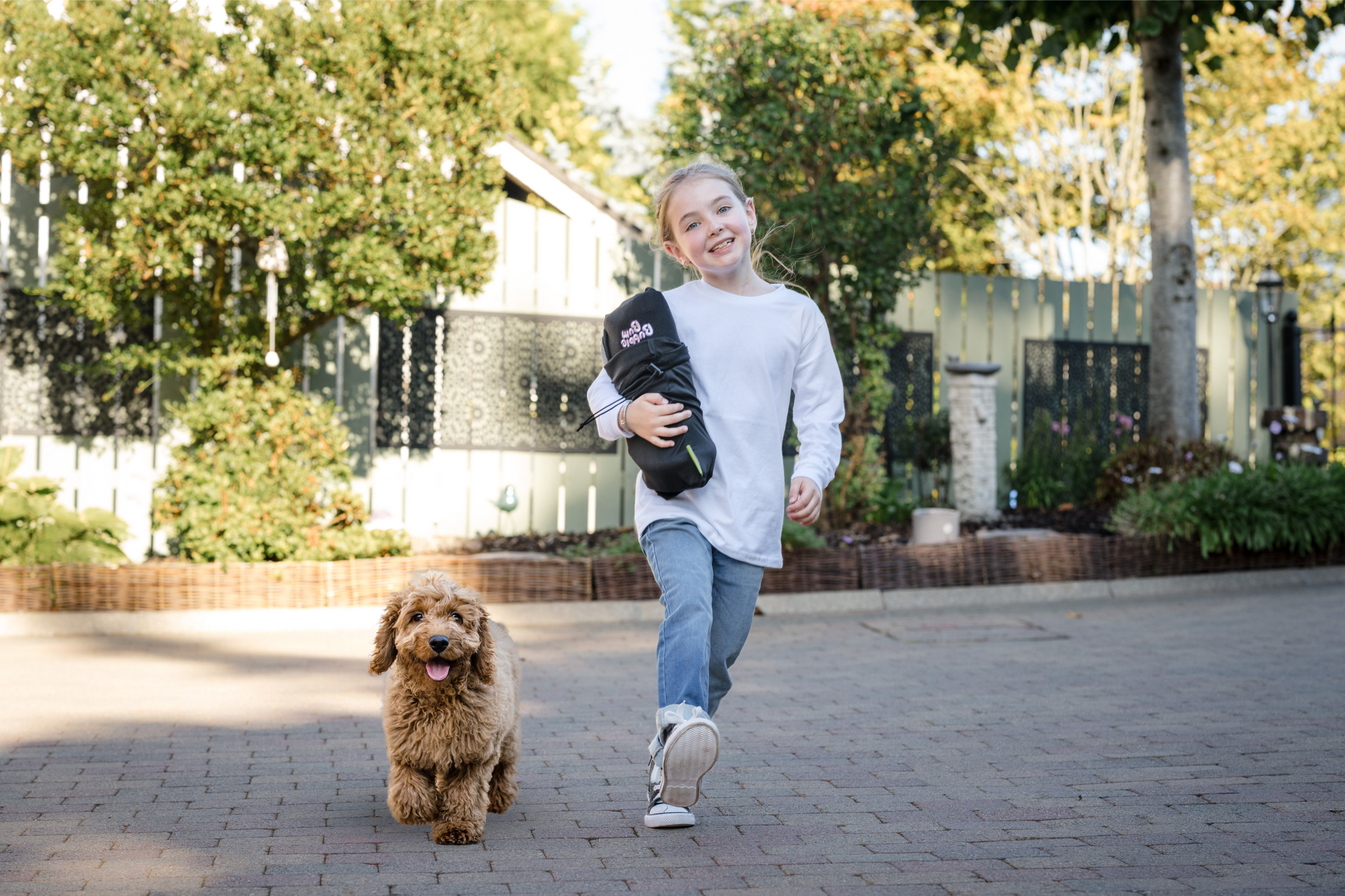 Baby girl walking with a dog