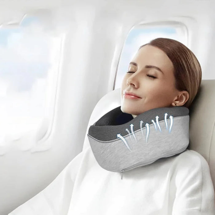 A woman resting on an airplane with a gray neck pillow; blue arrows indicate airflow through the breathable mesh interior to highlight cooling properties.